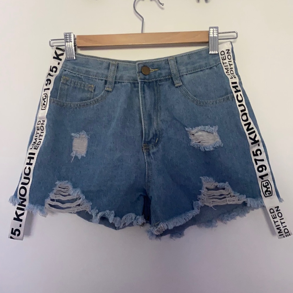 White tag, blue ripped Shein shorts